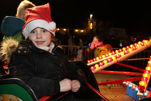 Mya enjoys a spin on the Merry Go Round in Crossmaglen Square. INNR4809
