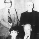 Mr Sam Crozier (seated) with young Gary Glenny, pictured after the presentation of an armchair to Mr Crozier at the Warrenpoint Presbyterian Chuch Hall in 1978. Also in the picture are Mr Ernest McGuffin, Rev. S.H. Williamson and Mr Albert Guy.