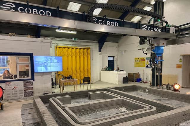 Printing of a 3D concrete house from the ground up.