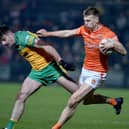 Armagh's Rian O'Neill fends off Donegal's Caolan McGonagle during last year's league encounter.