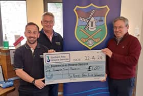 Gerry Grant & Warrenpoint GAA Club Chairman Paul McKibben present a cheque to Southern Area Hospice's James McCaffrey (left).