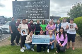 Pictured is Emma McGivern (fundraisng officer) accepting the cheque from the staff at St Patricks Primary