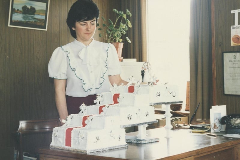 Cecelia McKey, an officer worker, pictured with a wedding cake made for Tommy and Theresa Downey in the 1980s. Many local wedding couples had their wedding cake made at McCann’s.