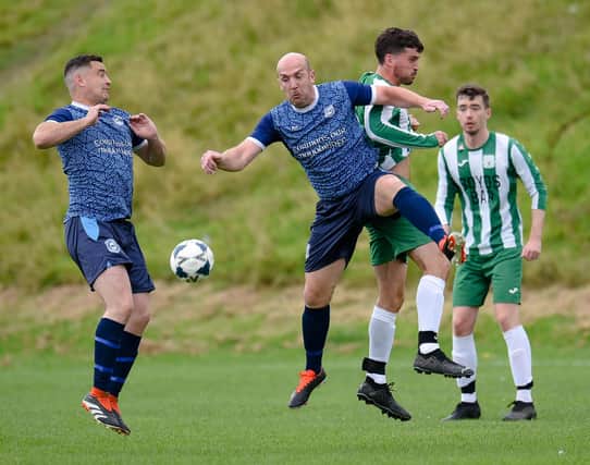 Mayobridge midfielder Miceal Lively contests a high ball with Greenfield Captain James Boyd at Derrybeg Pictures: Brendan Monaghan BM01