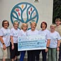 Deborah Kennedy and friends present a cheque for £9804.97 to Evora Hospice.
