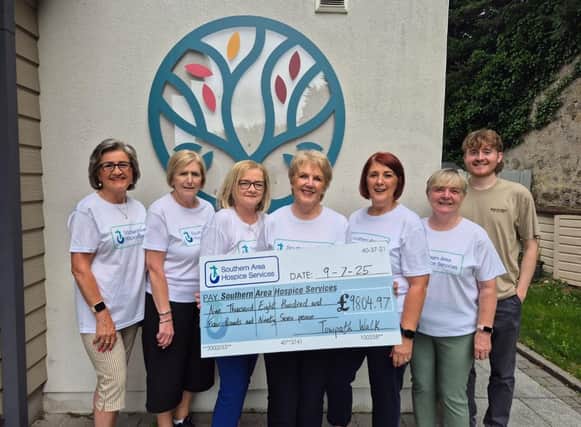 Deborah Kennedy and friends present a cheque for £9804.97 to Evora Hospice.