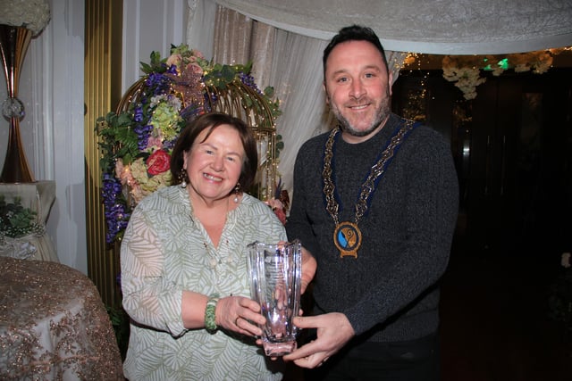 Chairperson Newry, Mourne and Down Council, Councillor Pete Byrne presents Brenda Sloan with her long service recognition award.