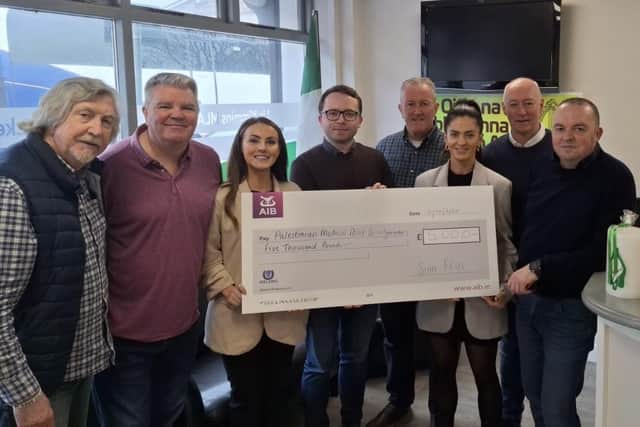 Event organisers with cheque for £5,000 in aid of the Palestinian Medical Relief Society, (L to R), Mickey Brady MP, Cathal Boylan MLA, Cllr. Sarah Duffy, Dáire Hughes, Conor Murphy MLA, Cllr. Aoife Finnegan, Cllr. Declan Murphy, Cllr. Aidan Mathers.