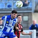 Newry’s Darren King heads clear under pressure from Crusaders' Paul Heatley. Picture: Stephen Hamilton/Inpho