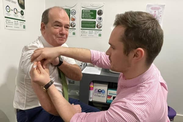 Chief Medical Officer Professor Sir Michael McBride and Mark O’Kane, pharmacist at Woodbourne Pharmacy.