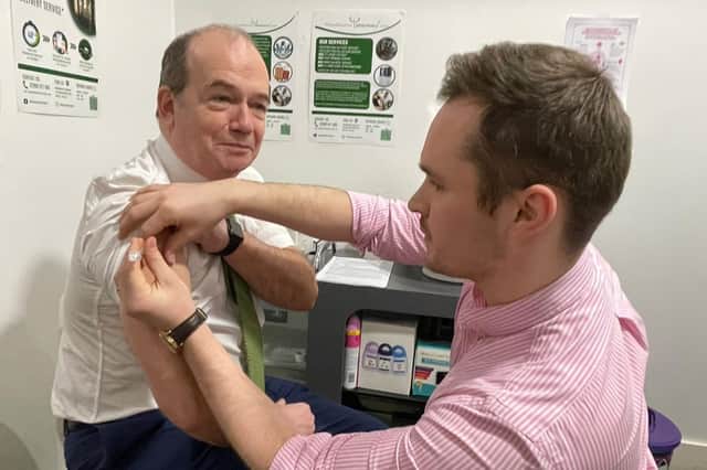 Chief Medical Officer Professor Sir Michael McBride and Mark O’Kane, pharmacist at Woodbourne Pharmacy.