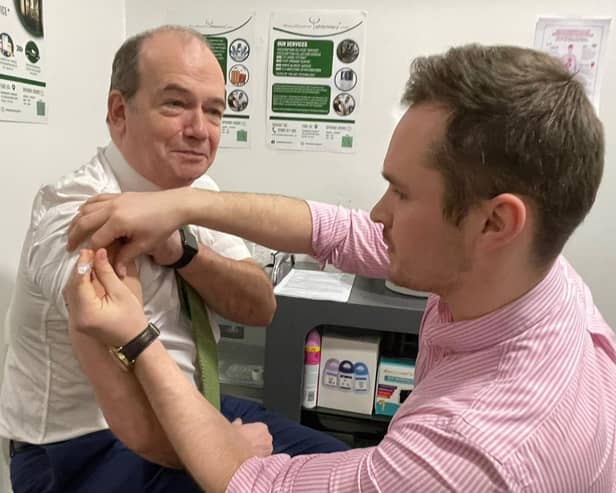 Chief Medical Officer Professor Sir Michael McBride and Mark O’Kane, pharmacist at Woodbourne Pharmacy.