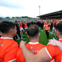 Armagh manager Kieran McGeeney speaks with his players.