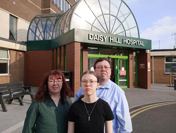 Liam Reichenberg with his wife Siobhan, and their 14-year-old daughter Aoife, standing outside Daisy Hill Hospital where the teenager was born. Credit: family photograph