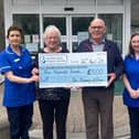 Eugene and Agnes are pictured presenting the cheque to nursing staff Jasmine Pescod and Jacqueline O'Rourke.
