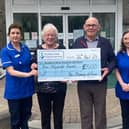 Eugene and Agnes are pictured presenting the cheque to nursing staff Jasmine Pescod and Jacqueline O'Rourke.
