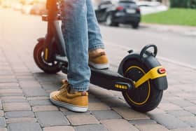 Image of an e-scooter. Pic posed by model.