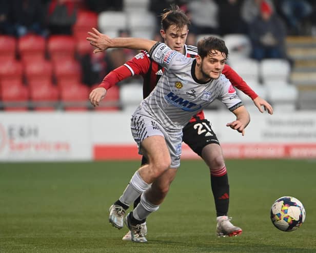 Crusaders' Mal Smyth in action with Newry’s  Lorcan Forde. Pic: Inpho/Stephen Hamilton