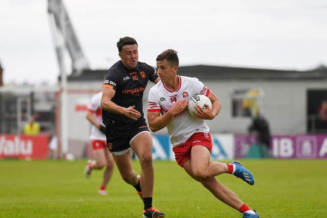 Derry’s Shane McGuigan evades a challenge from Armagh’s Stefan Campbell. Photo: George Sweeney