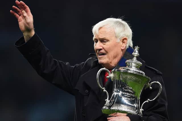Northern Ireland and Aston Villa legend Peter McParland holds the FA Cup and waves to the crowd in 2014. (Photo by Laurence Griffiths/Getty Images)