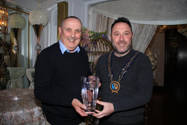 Chairperson Newry, Mourne and Down Council, Councillor Pete Byrne presents Thomas McElroy with his long service recognition award.