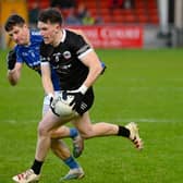 Miceal Rooney races past Scotstown's Darren Hughes at Pairc Esler when the sides met last year in the Ulster quarter-final. Pic: Brendan Monahan