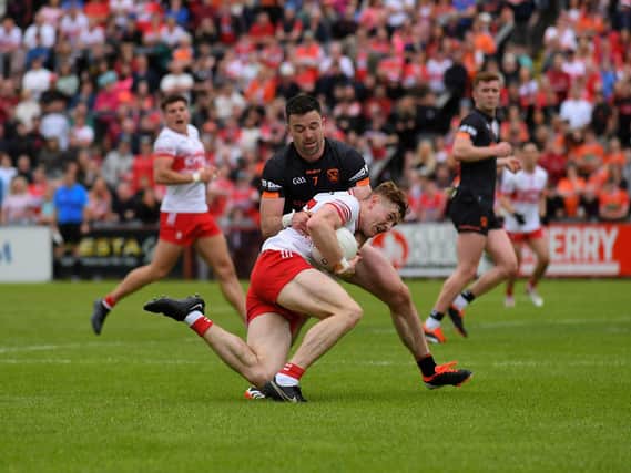 Armagh ‘s Adam Forker grapples with Derry’s Lachlan Murray. Photo: George Sweeney