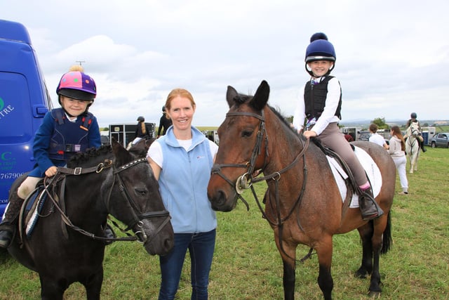 Penny and Sally O'Hare on Gonzo and Tinkerbell with Mum Sarah as they wait to enter the competition. INNR2626