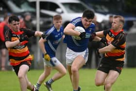 Ryan Garvey powers his way past Cullyhanna's Mickey Murray.