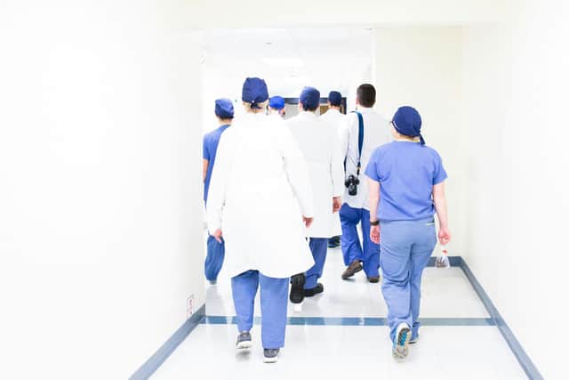"A multidisciplinary medical team walking through a hospital corridor, reflecting Newry’s path toward integrated community care"