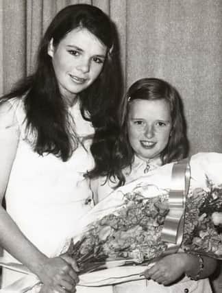 Rosemary O’Hagan, daughter of Mr P O’Hagan, Clerk of Newry No. 1 Rural District Council, presenting a bouquet of flowers to Dana at a reception marking the naming of “Dana Place,” Hilltown. Courtesy of The Outlook