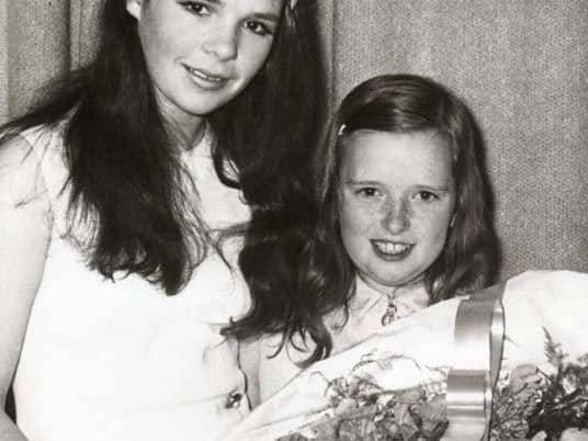 Rosemary O’Hagan, daughter of Mr P O’Hagan, Clerk of Newry No. 1 Rural District Council, presenting a bouquet of flowers to Dana at a reception marking the naming of “Dana Place,” Hilltown. Courtesy of The Outlook