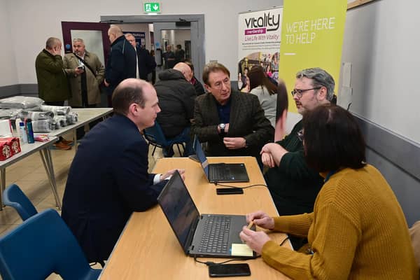 Minister Lyons is pictured with representatives from NIE.