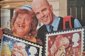 Pantomime dame, May McFettridge launches Royal Mail's Christmas stamps with Newry postman Anthony Morgan.