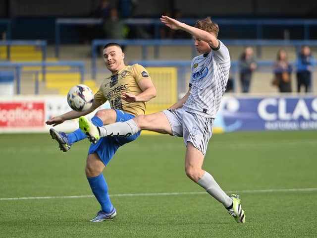Coleraine’s Josh Carson and Newry’s Brian Healy battle for possession. Pictures: INPHO/Stephen Hamilton