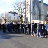 Members of Carlingford Lough Currach Club take the final lift at Tom (Baker) McCann's funeral in Warrenpoint. INNR1029