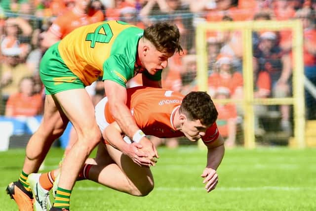 Donegal's Hugh McFadden and Armagh's Jarly Og Burns wrestle for possession during the Ulster Final.