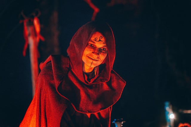 Spooky costumed character greeting visitors.