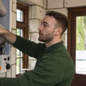An OFTEC technician checking a boiler