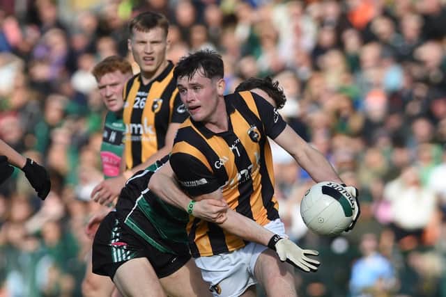 Crossmaglen wing back Harry Cumiskey looks to offload possession under pressure.