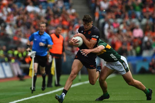 Armagh's Niall Grimley powers past Kerry's Mike Breen.