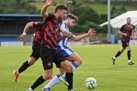 Newry City's Lorcan Forde and Warrenpoint Town's Christopher Crane contest possession during Friday night's Boyle Sports Championship encounter. Pic: Brendan Monaghan