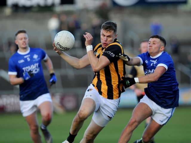 Crossmaglen's Oisin O'Neill drives past Clan's Michael McConville