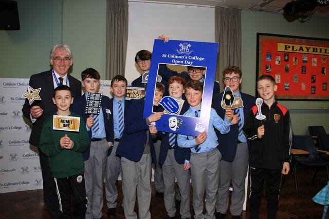 Pupils and visiting P7 students along with Principal Cormac McKinney each take a prop for the photograph in the Drama Department. INNR0551