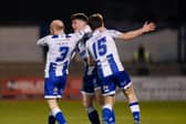 Noel Healy and Lorcan Forde celebrate with Evan McEnteggart after his goal against Dundela. Pic: Brendan Monaghan