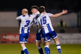 Noel Healy and Lorcan Forde celebrate with Evan McEnteggart after his goal against Dundela. Pic: Brendan Monaghan