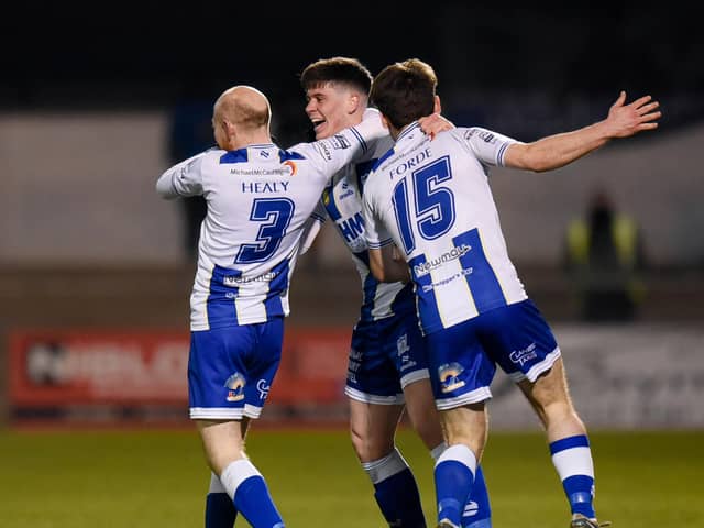 Noel Healy and Lorcan Forde celebrate with Evan McEnteggart after his goal against Dundela. Pic: Brendan Monaghan