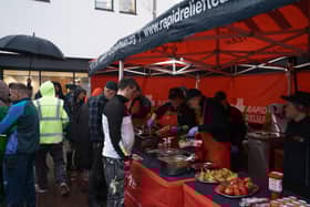 RRT volunteers serve food to local residents